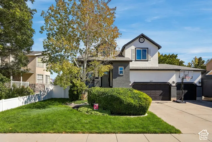 Stucco and brick exterior with dark trim accents
