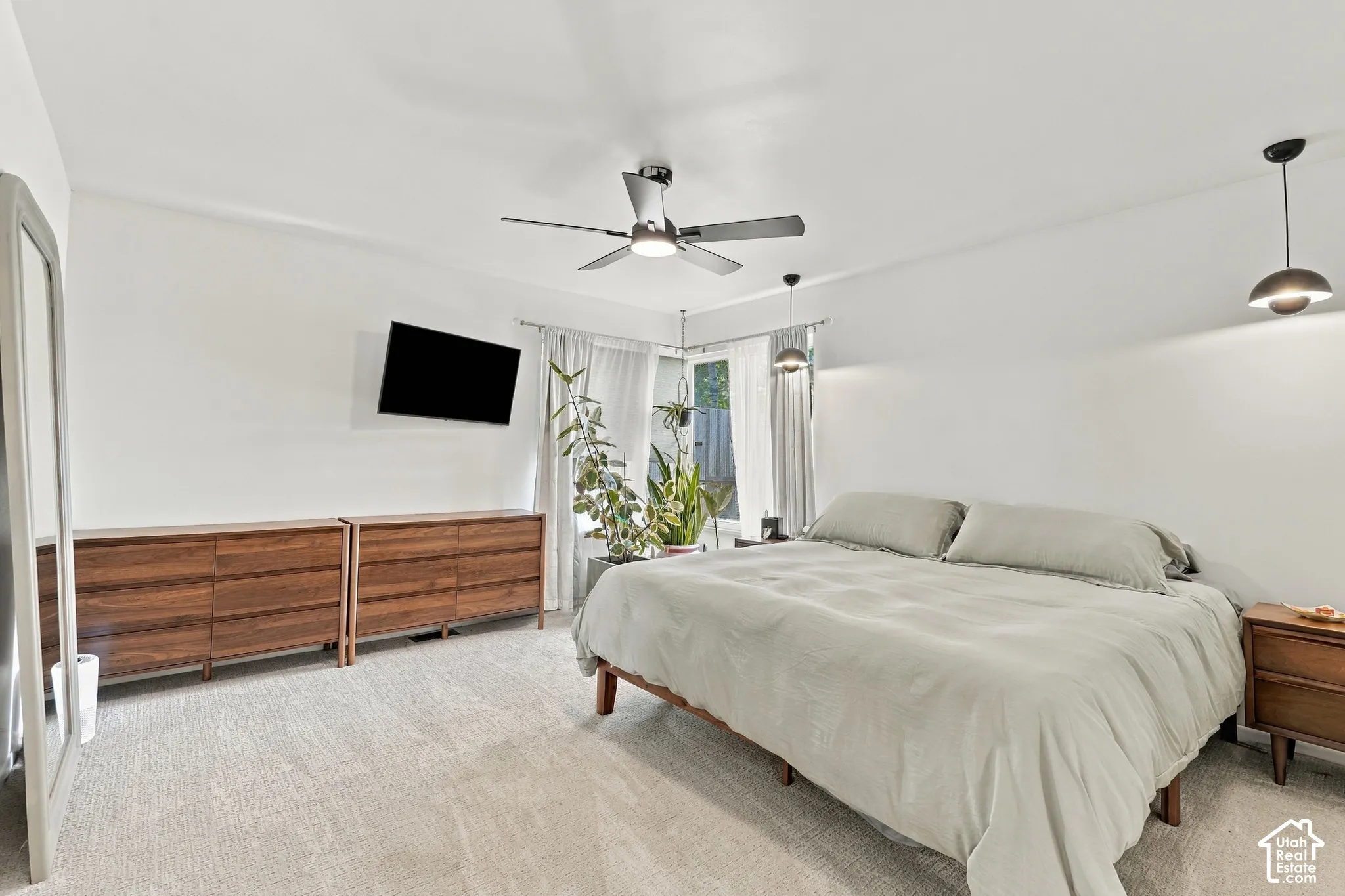 Bright interior space with light-toned carpeting, ceiling fan, and recessed lighting