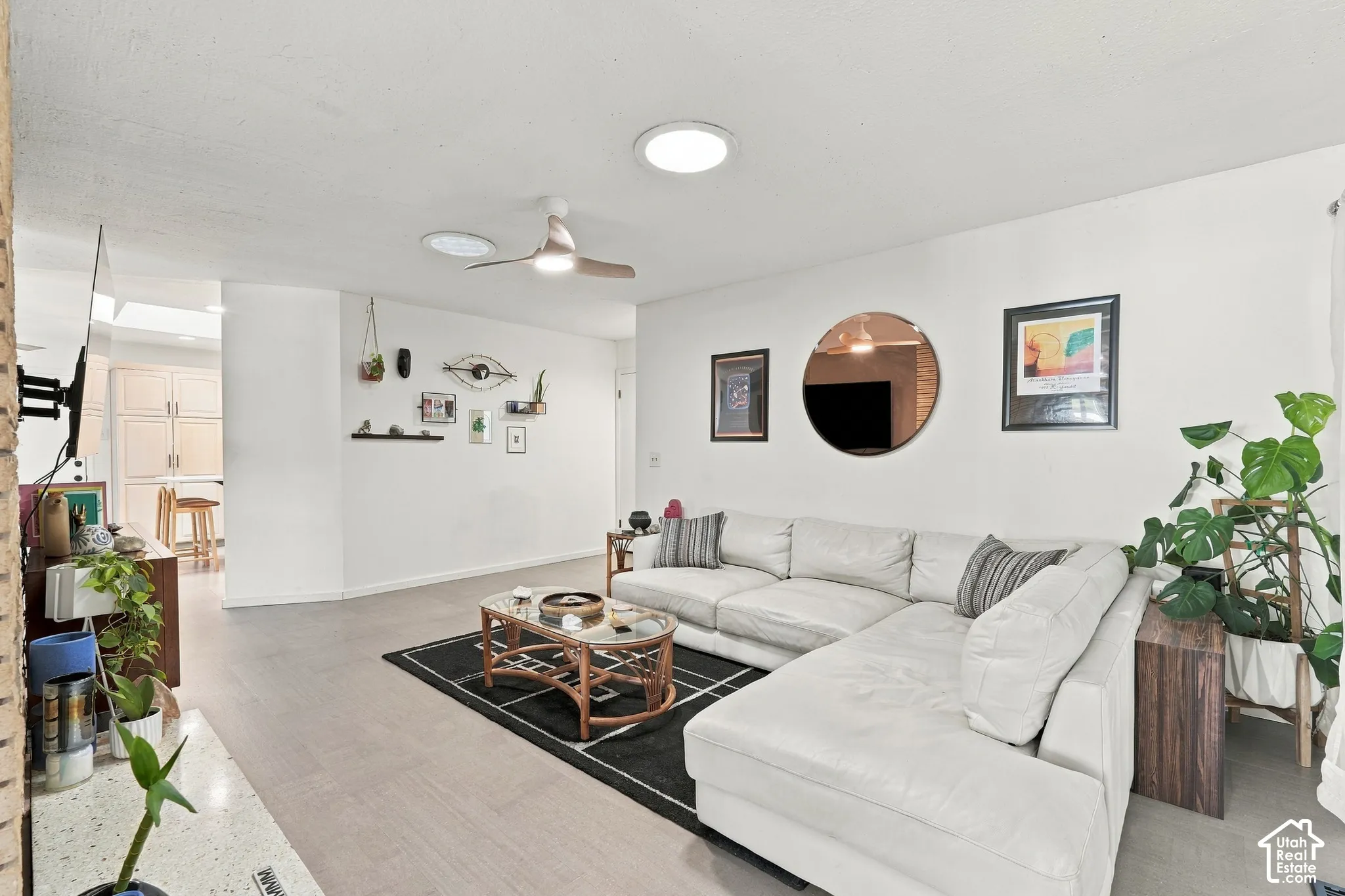 Recessed ceiling lighting, ceiling fan, wood-finish flooring, and light-toned walls