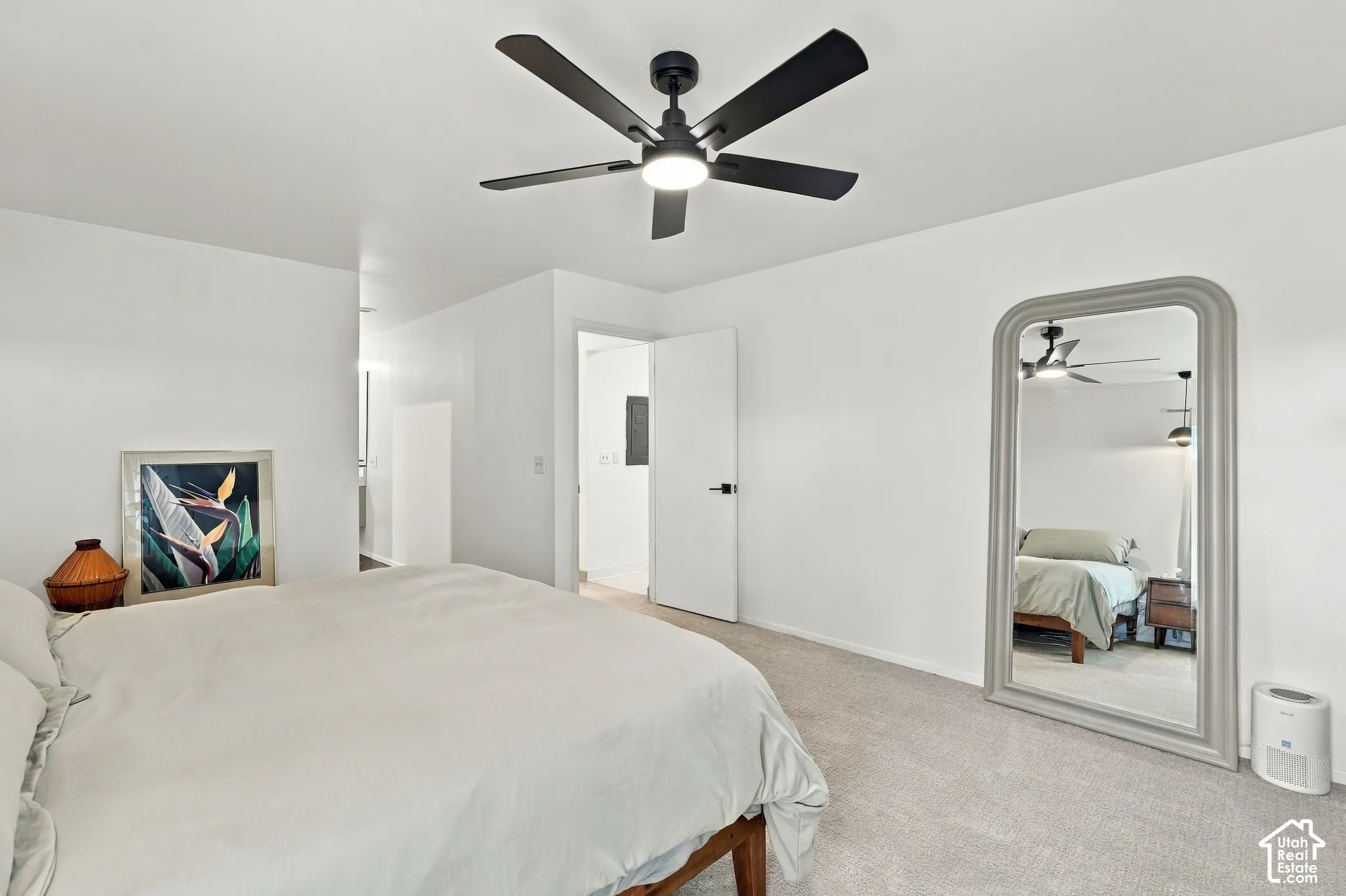 White walls with a ceiling fan, carpeted flooring, and a full-length mirror