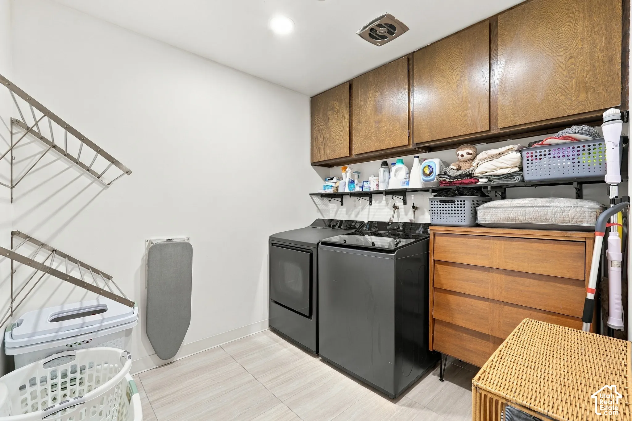 Light-toned tile flooring with white walls and overhead recessed lighting