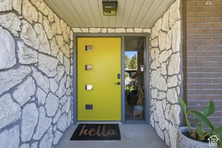 Bright yellow entry door with multiple small square windows