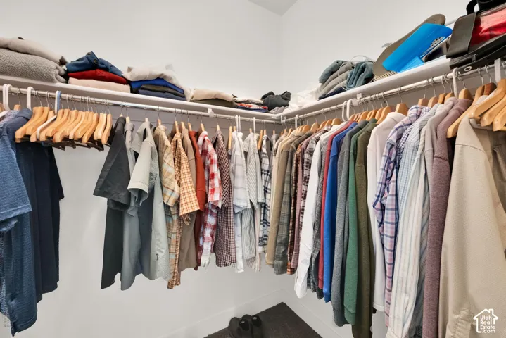 U-shaped closet system with multiple hanging rods and integrated upper shelving