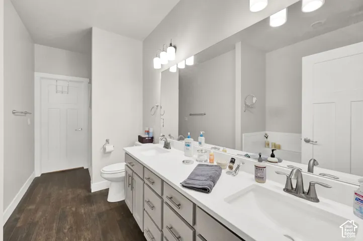 Dual vanity with white countertops, undermount sinks, and brushed nickel fixtures