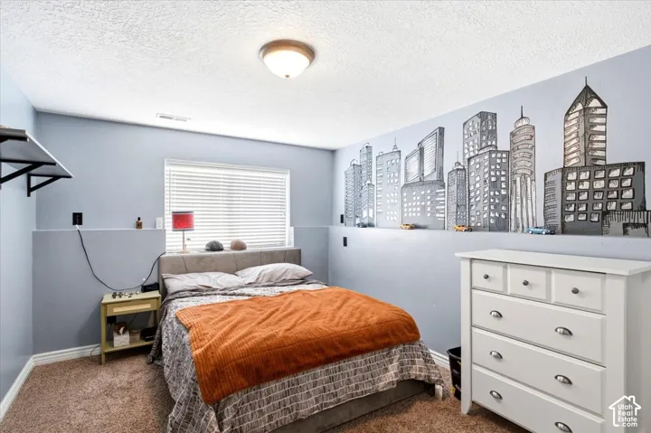 Wall-mounted shelving unit, window with blinds, ceiling-mounted light fixture, carpeting