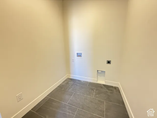 Laundry area with tile flooring and utility hookups
