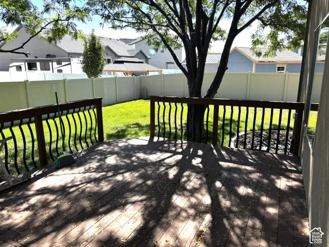 Wood deck with dark railing and decorative balusters
