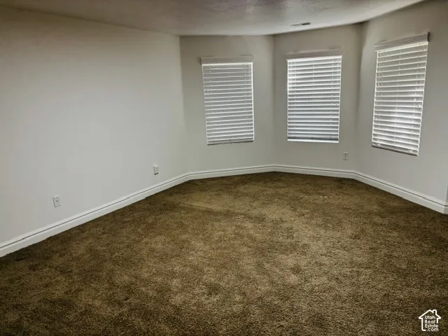 Recessed bay window with three window units, each fitted with white horizontal blinds