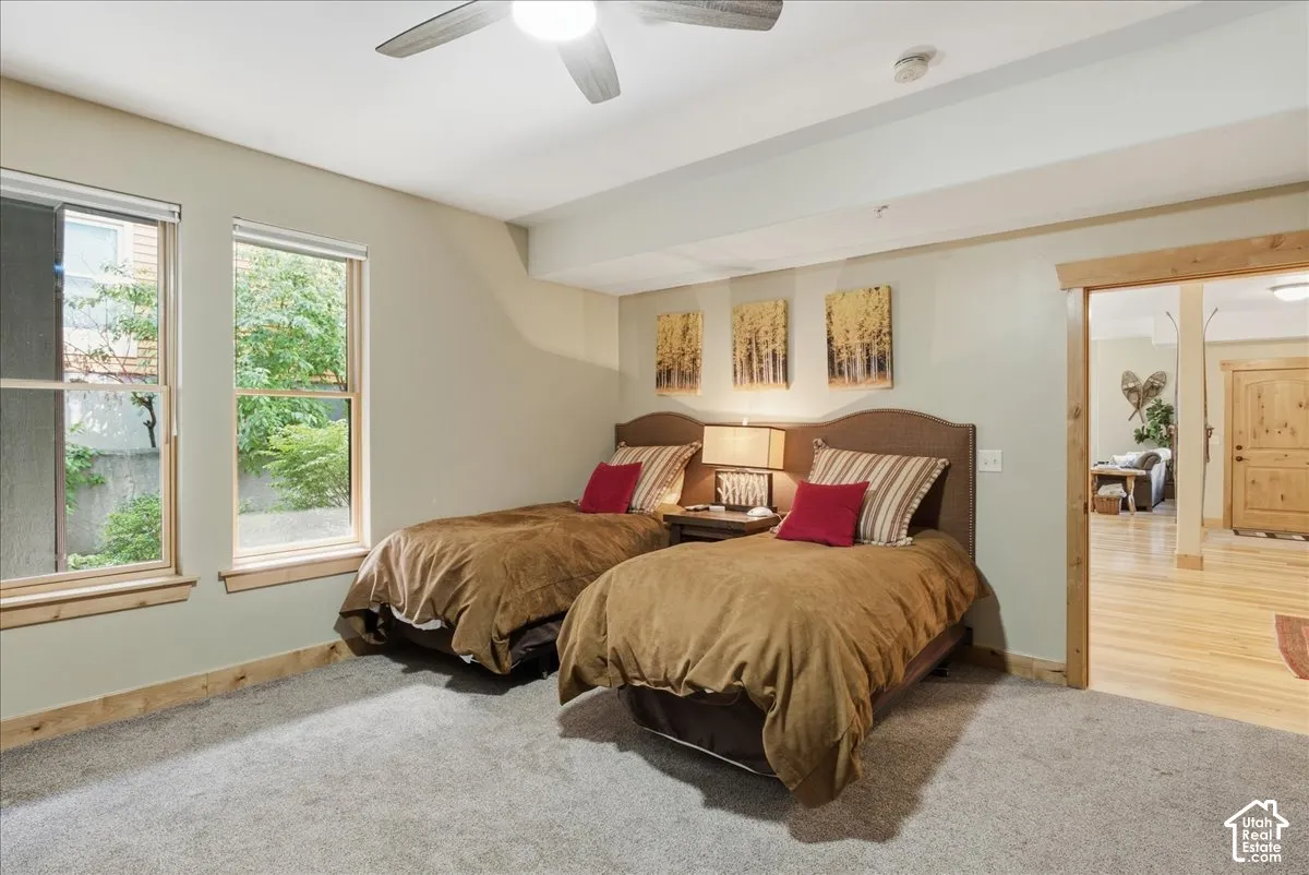 Recessed lighting, wood-trimmed windows, a ceiling fan, and carpeted flooring
