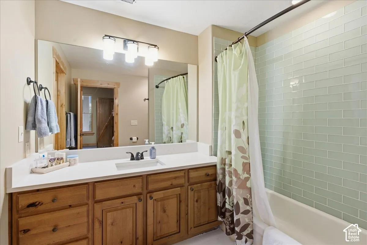 Wood-finish vanity with a white countertop and integrated sink