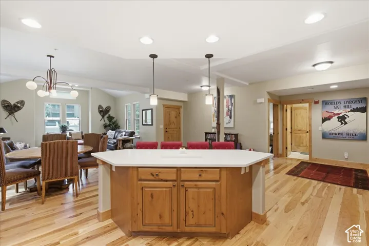 Kitchen island with a white countertop and wood-finish cabinetry