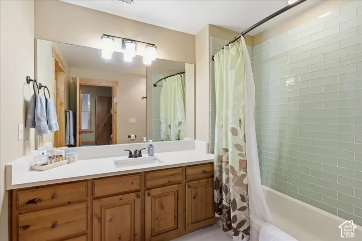 Wood-finish vanity with a white countertop and integrated sink