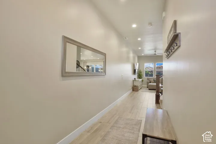 Recessed lighting illuminates the wood-finish flooring
