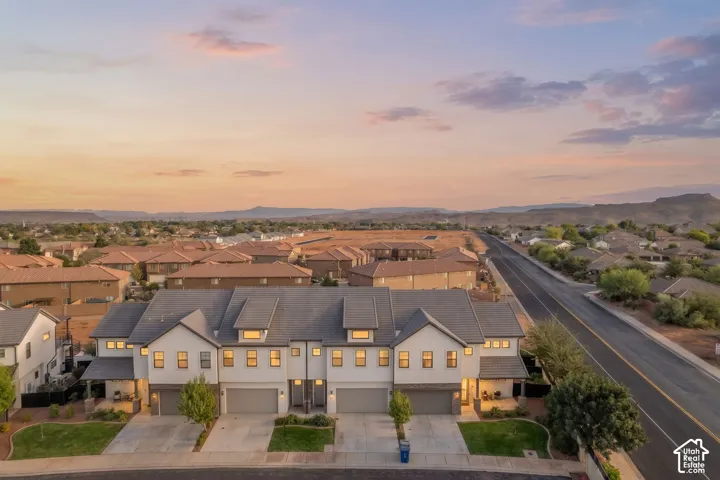 Modern townhome exteriors with attached garages, covered entryways, and contrasting trim details