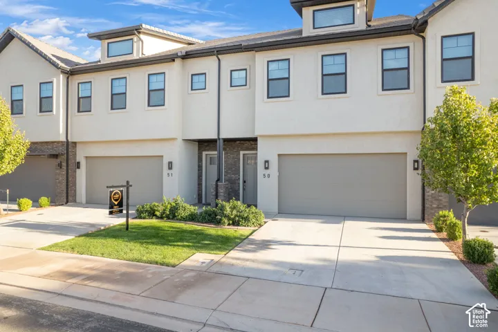 Modern stucco exterior with dark trim windows