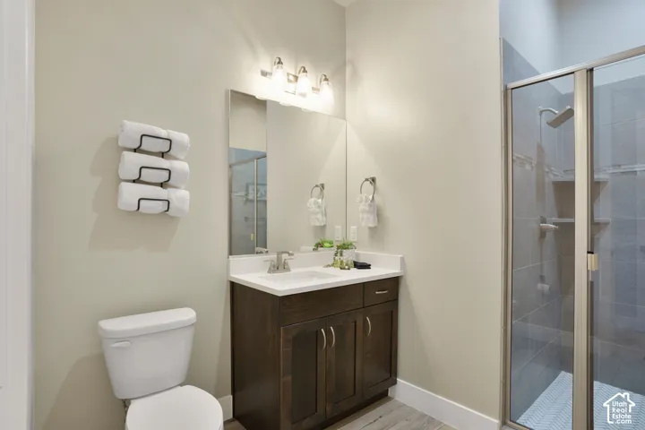 Dark wood-finish vanity with a white countertop and rectangular sink