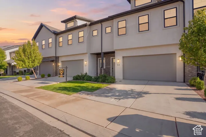 Modern exterior with stucco finish and dark trim accents