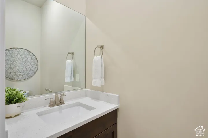Vanity featuring an integrated sink, brushed nickel faucet, and a light-toned countertop