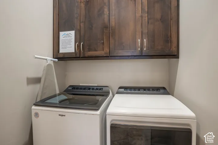 Built-in wood-finish cabinetry provides storage above the appliances