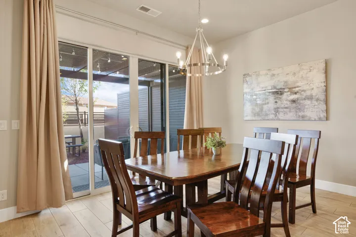 Recessed lighting, wood-finish flooring, and a contemporary chandelier