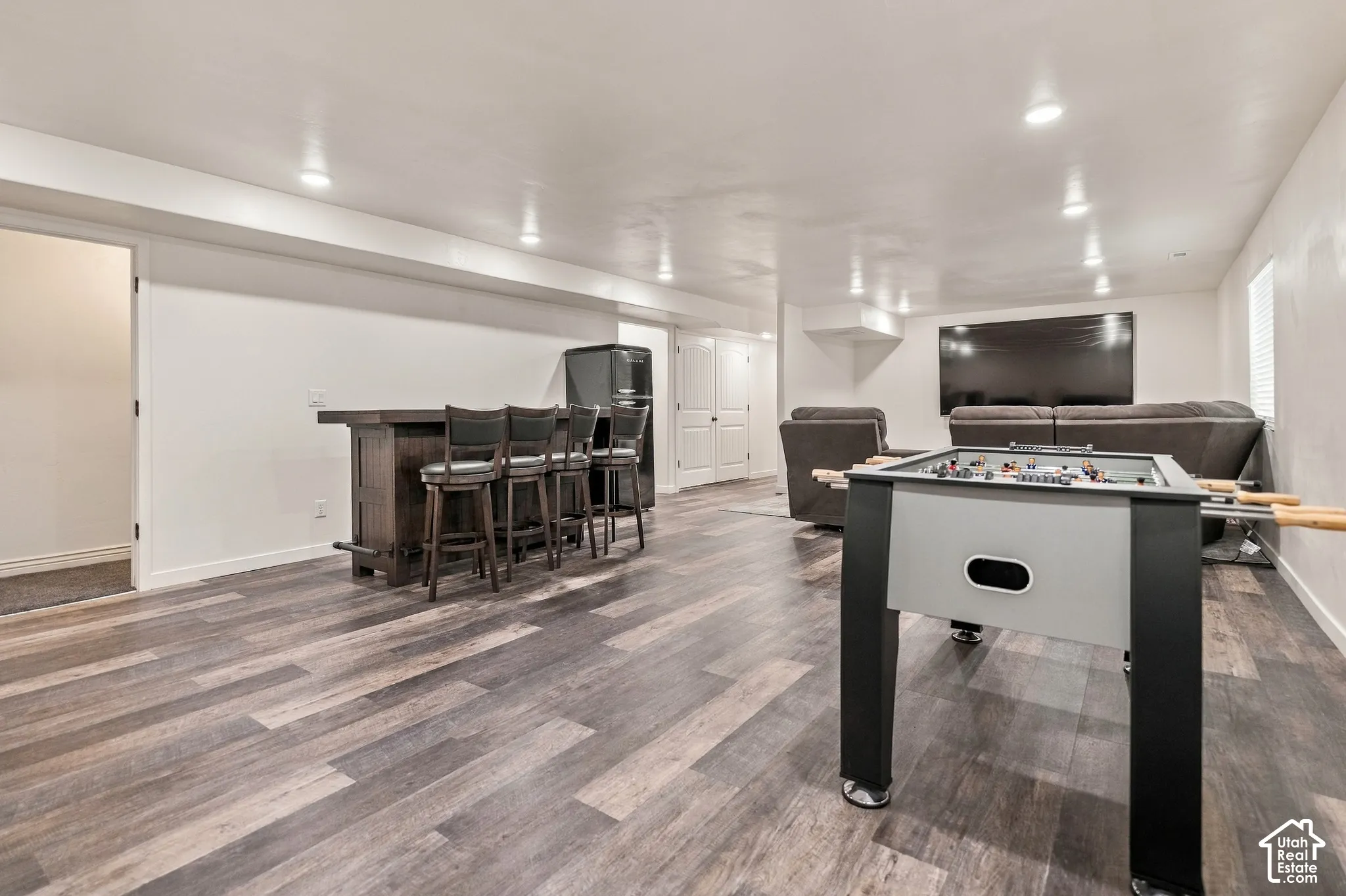 Spacious open concept room featuring wood-finish flooring and recessed lighting