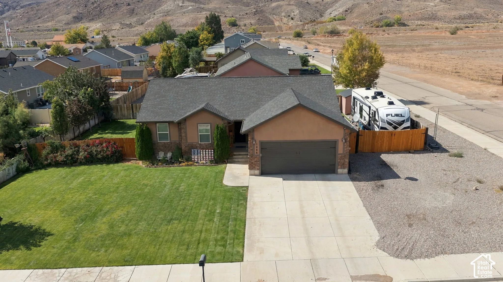 Ranch-style exterior with a hip roof, attached garage, and a concrete driveway