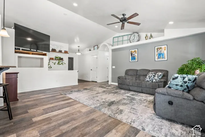 Vaulted ceiling, ceiling fan, recessed lighting, wood-finish flooring, and built-in shelving