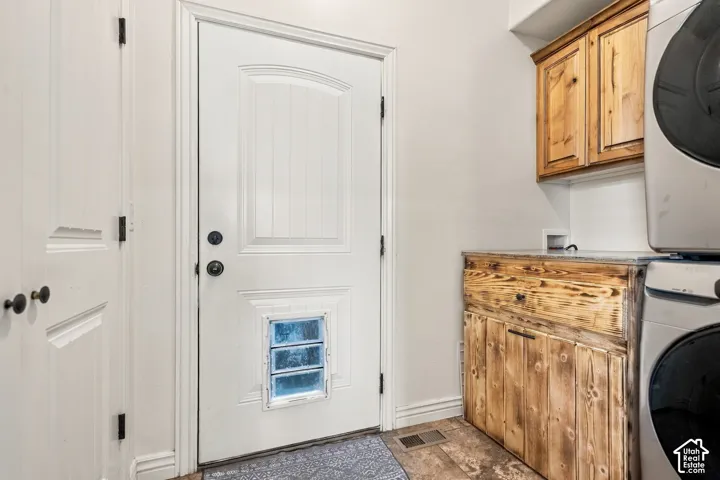 White paneled door, wood-finish flooring, wood cabinetry, and a countertop surface