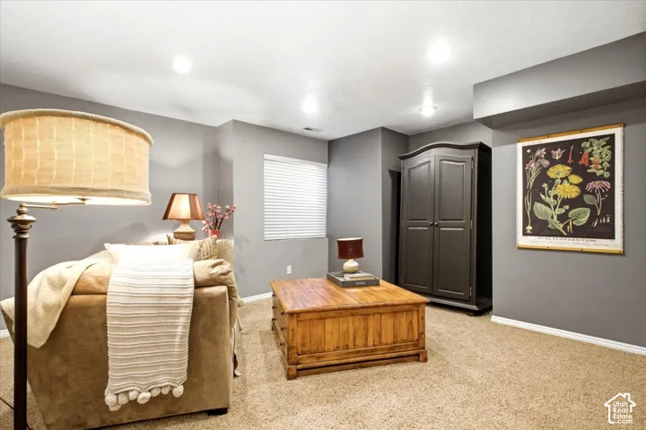 Recessed lighting, window with blinds, carpet flooring, painted walls, and ceiling with structural elements
