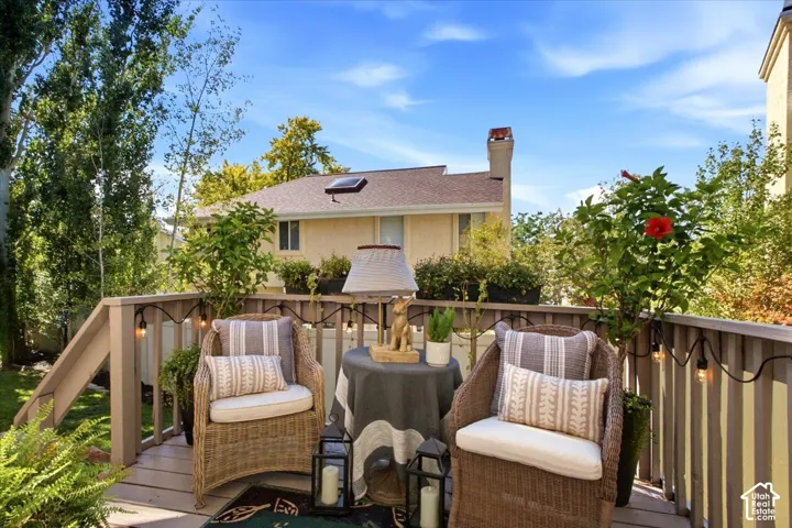 Multi-level deck with wood-finish railing and integrated lighting
