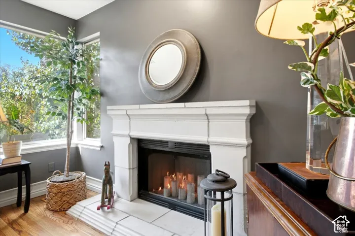 Fireplace featuring a classic white mantel, tile hearth, and dark grey wall finish