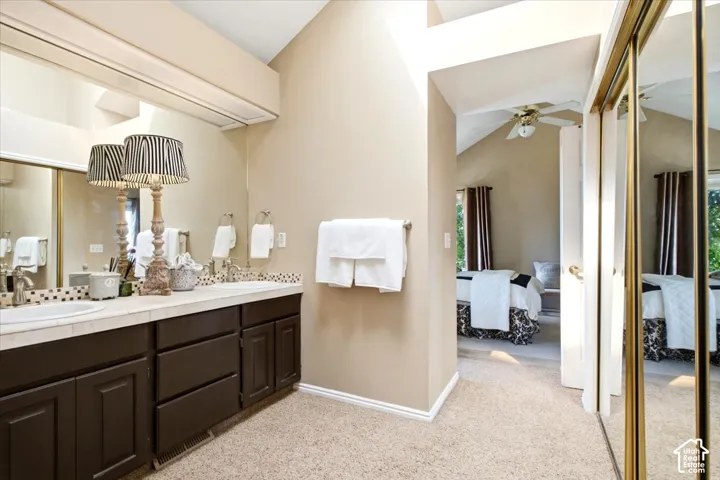 Dual vanity with dark wood-finish cabinetry and integrated sinks