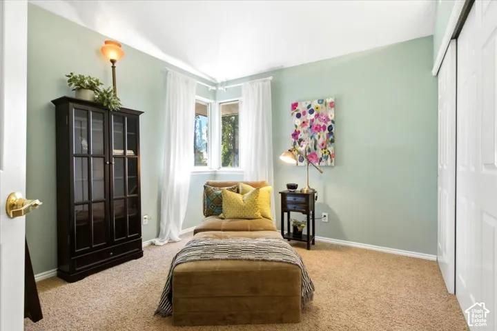 Corner windows with white privacy drapes and light-colored walls