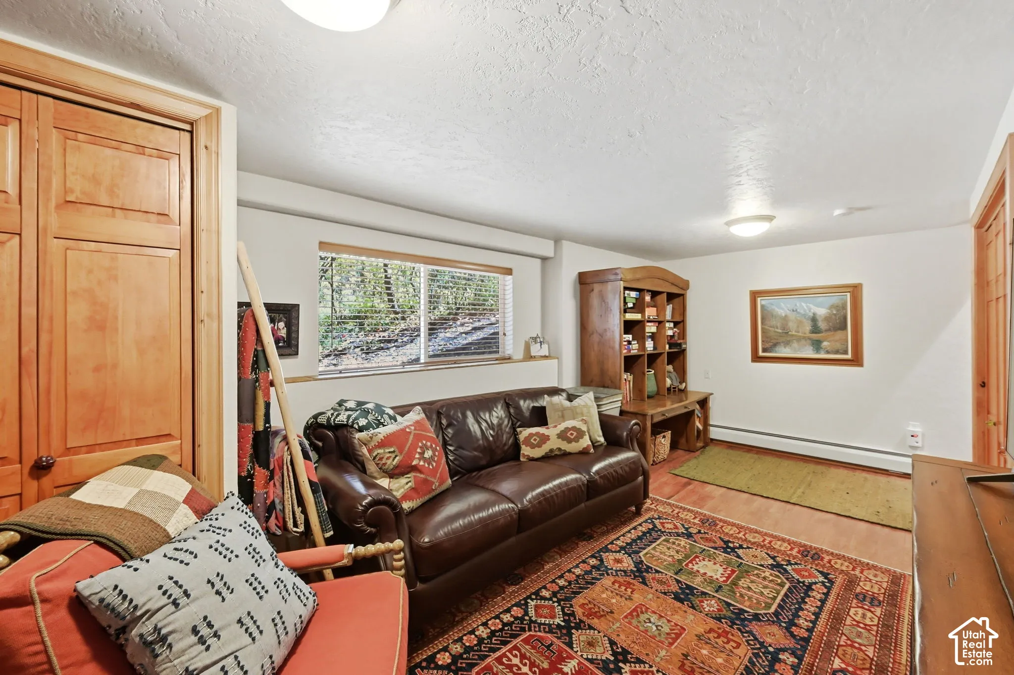 Wood-finish flooring with a durable finish, solid wood built-in storage, and natural wood trim throughout