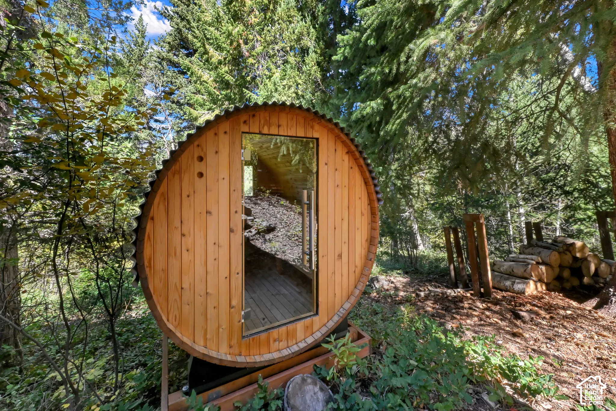 Barrel-shaped structure with wood plank exterior and corrugated metal roof
