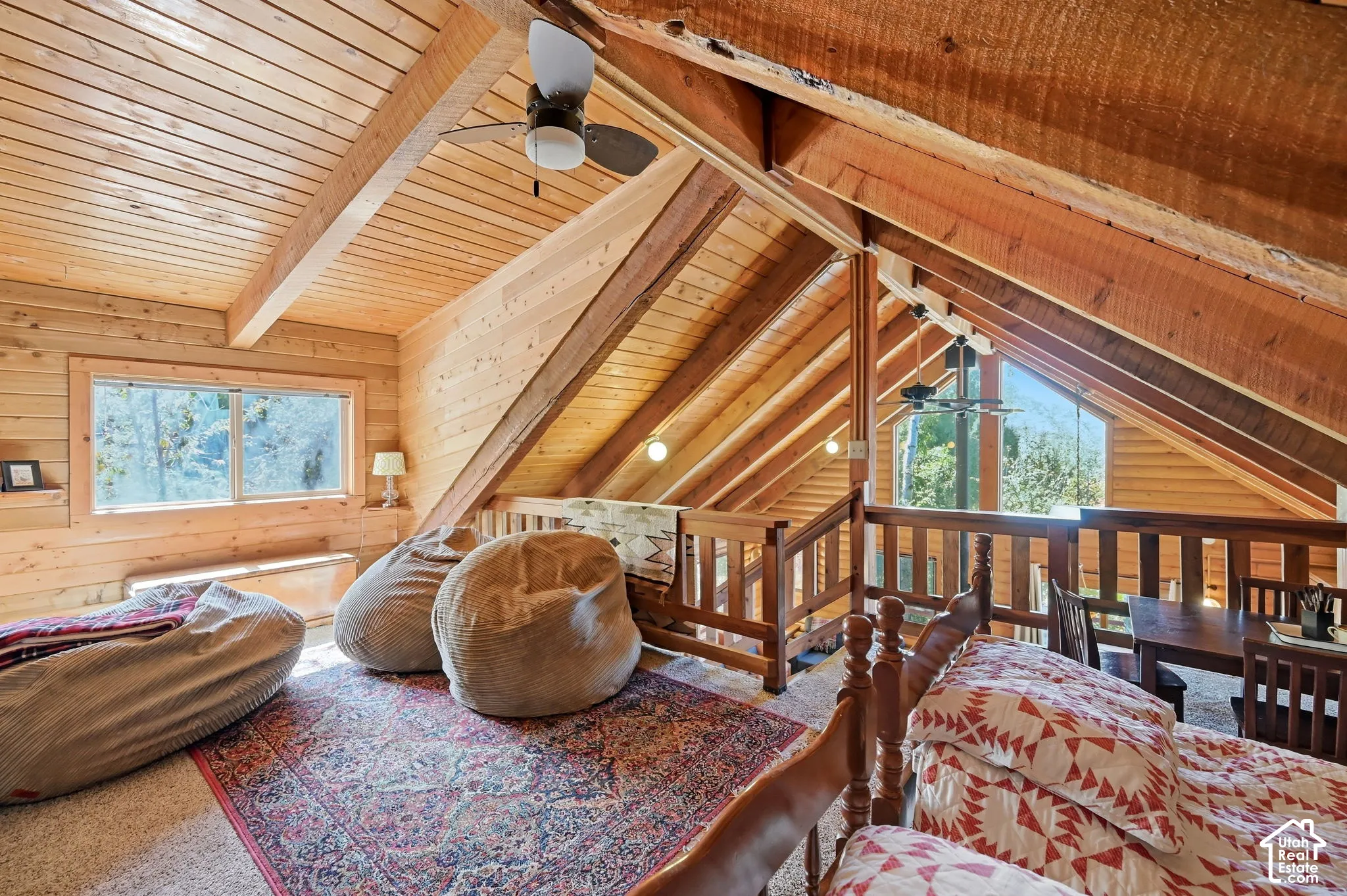 Vaulted wood-paneled ceilings with exposed beams, wood-finish walls, and wood railings
