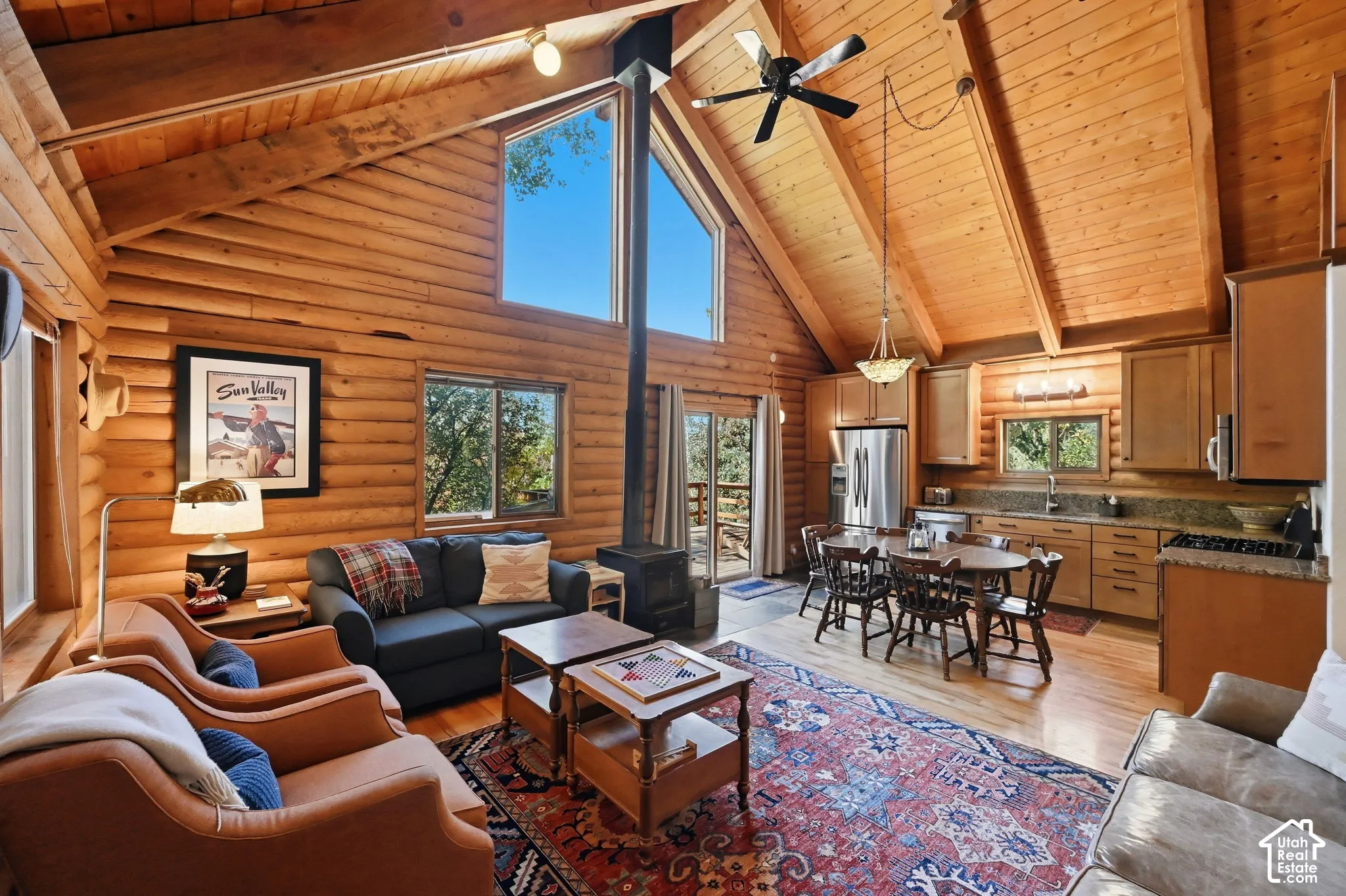 Open-concept living space featuring wood-finish walls and vaulted ceilings