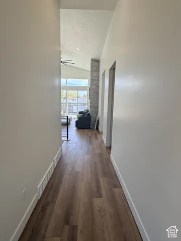 Wood-finish flooring throughout, bright white walls, and a recessed ceiling light