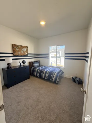 Recessed ceiling lighting, light neutral-toned carpeting, and a window with white trim