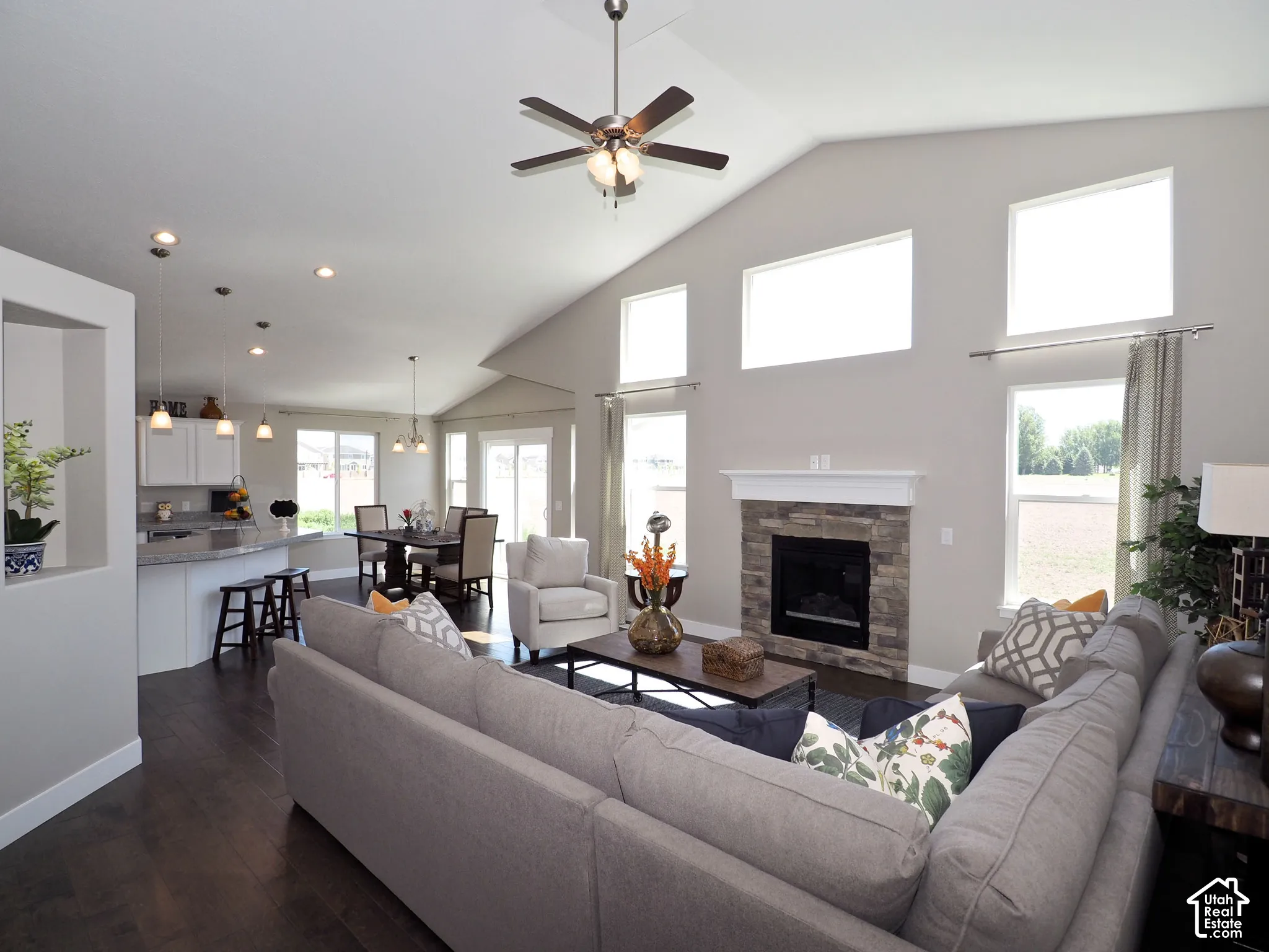 Vaulted ceiling with a ceiling fan, recessed lighting, and wood-finish flooring