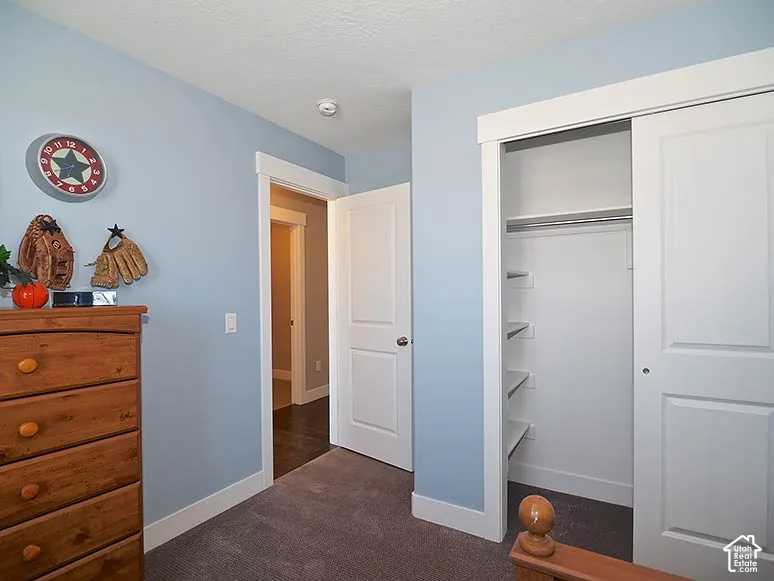 Built-in closet with sliding doors, interior shelving, and a hanging rod