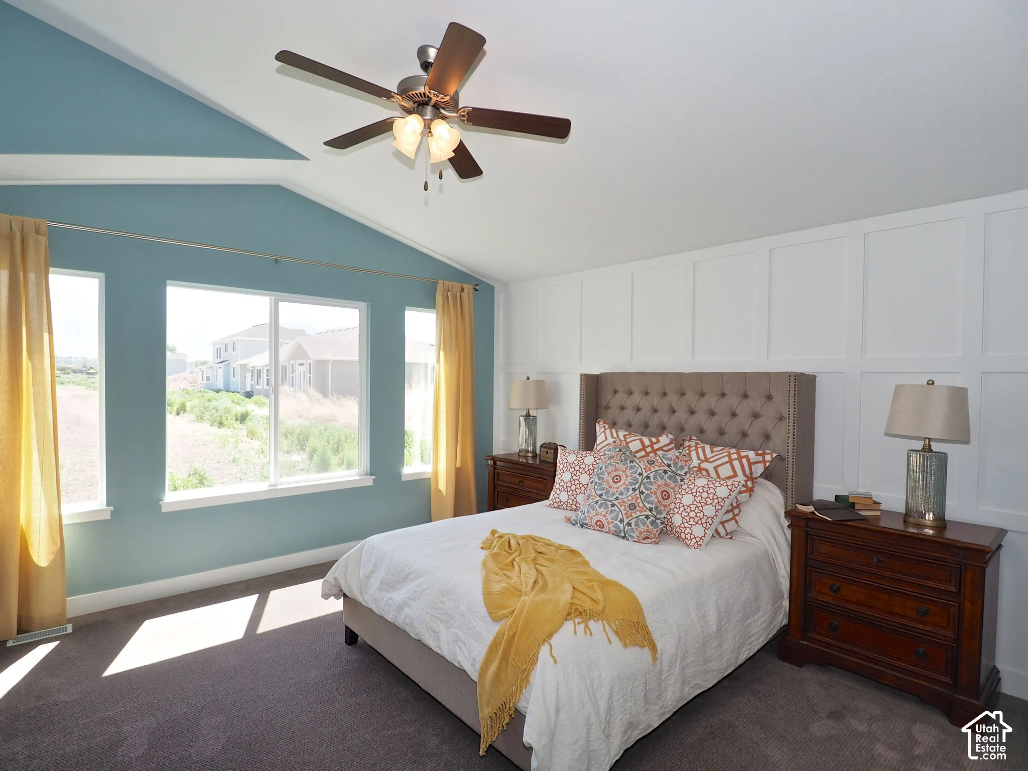 Accent wall with decorative paneling and a tufted headboard