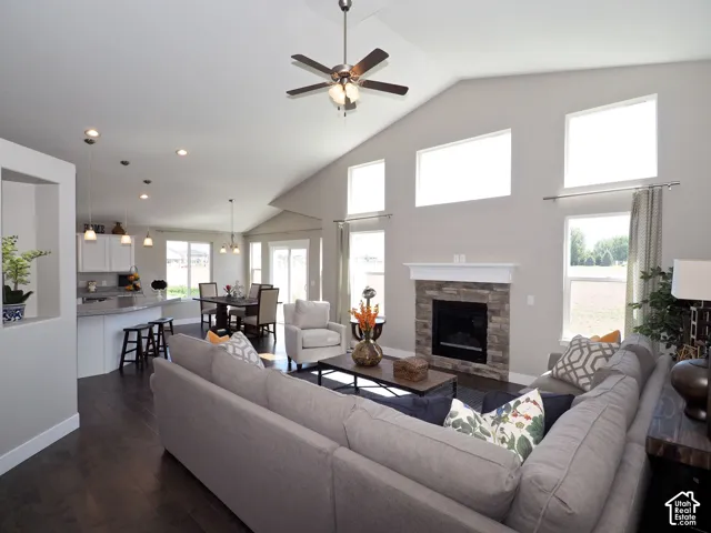 Vaulted ceiling with a ceiling fan, recessed lighting, and wood-finish flooring