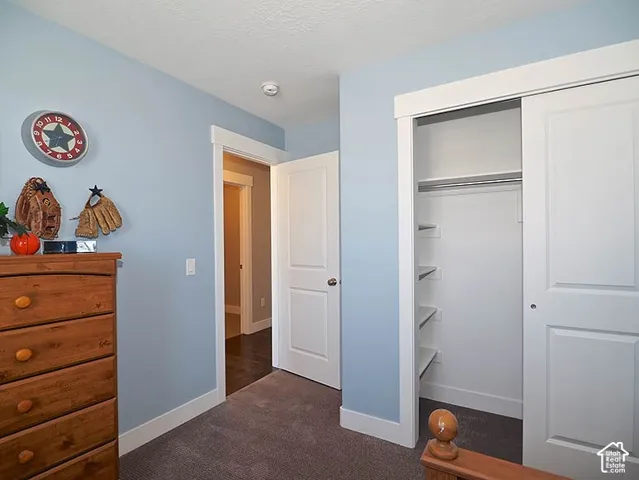 Built-in closet with sliding doors, interior shelving, and a hanging rod