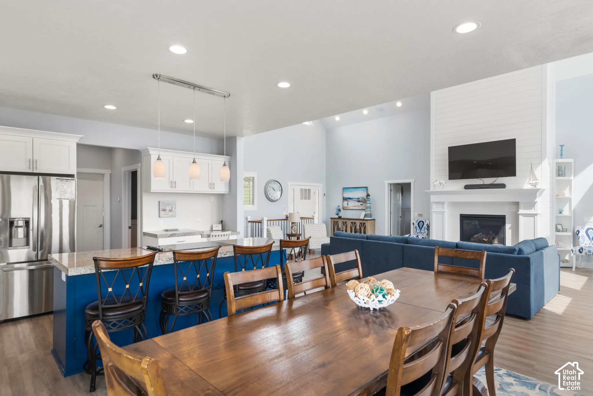 Open-concept living area with vaulted ceilings, recessed lighting, and wood-finish flooring