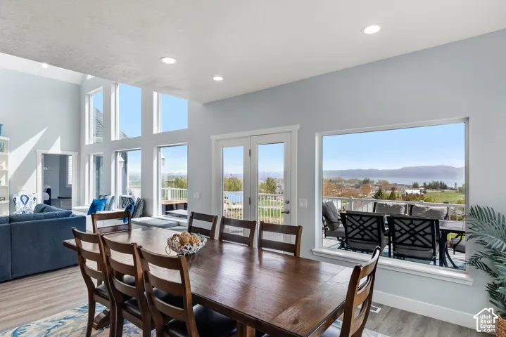 Wood-finish flooring throughout, with a tall wall of windows providing a bright interior