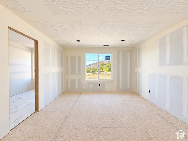 Drywall-ready interior with recessed lighting, a window, and exposed subflooring