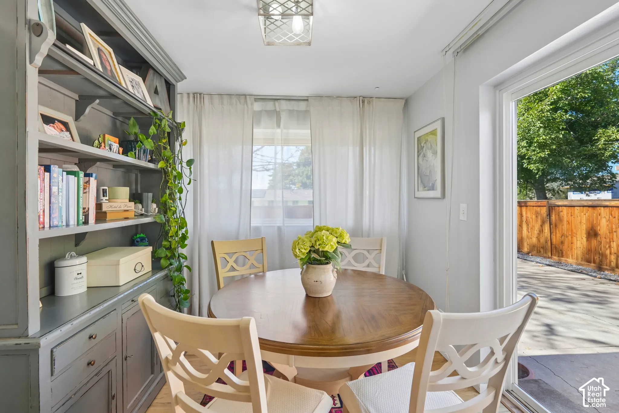 Built-in shelving with cabinetry, wood-finish flooring, and a sliding glass door