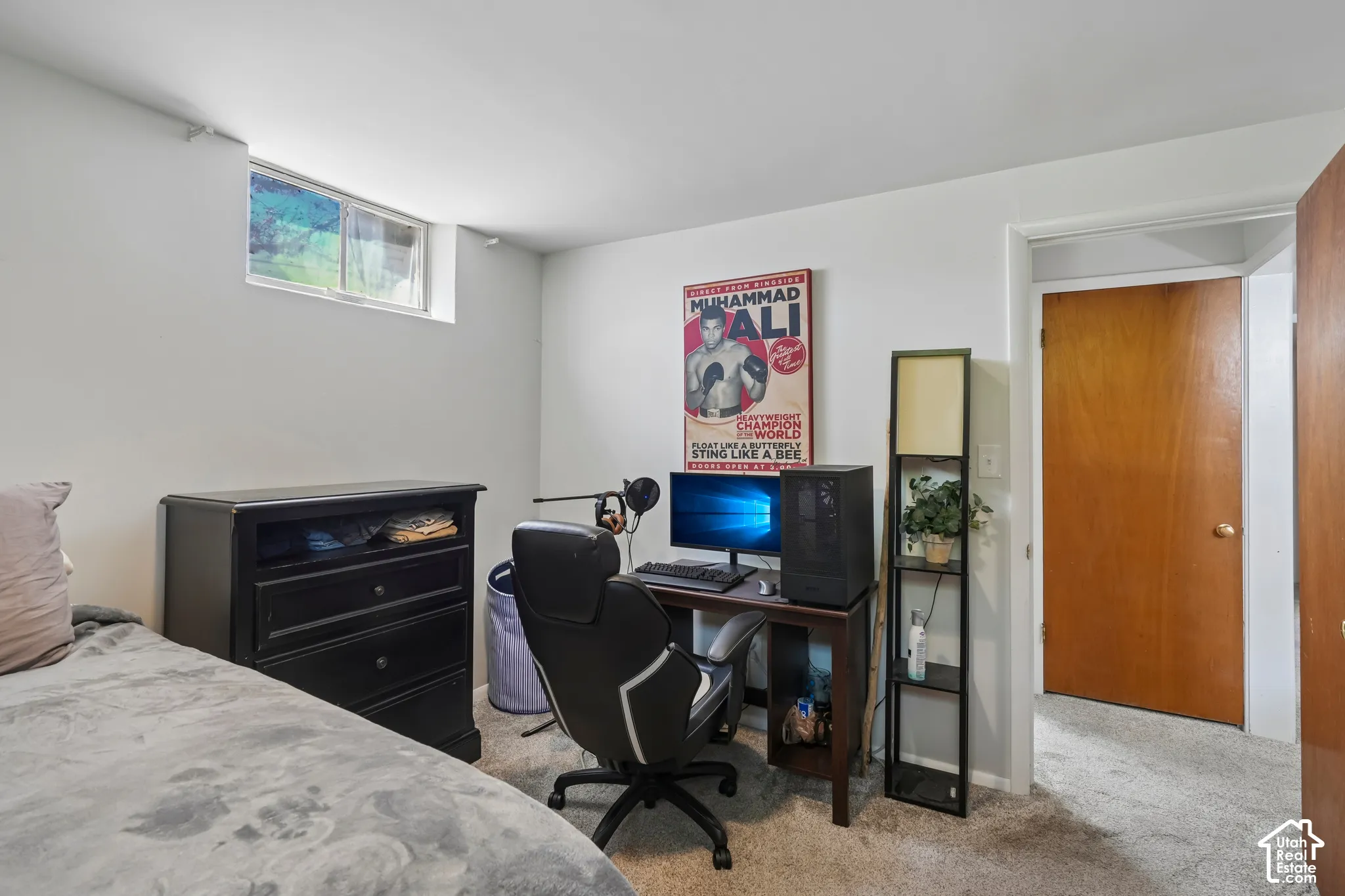 Carpeted flooring, egress window, white painted walls, and a solid core door