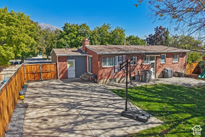 Red brick exterior with a gray siding accent